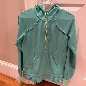 Cute Lululemon light weight layer with ruffle on the bottom. 3/4 zip with hood.